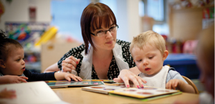 A childcare worker with two small children